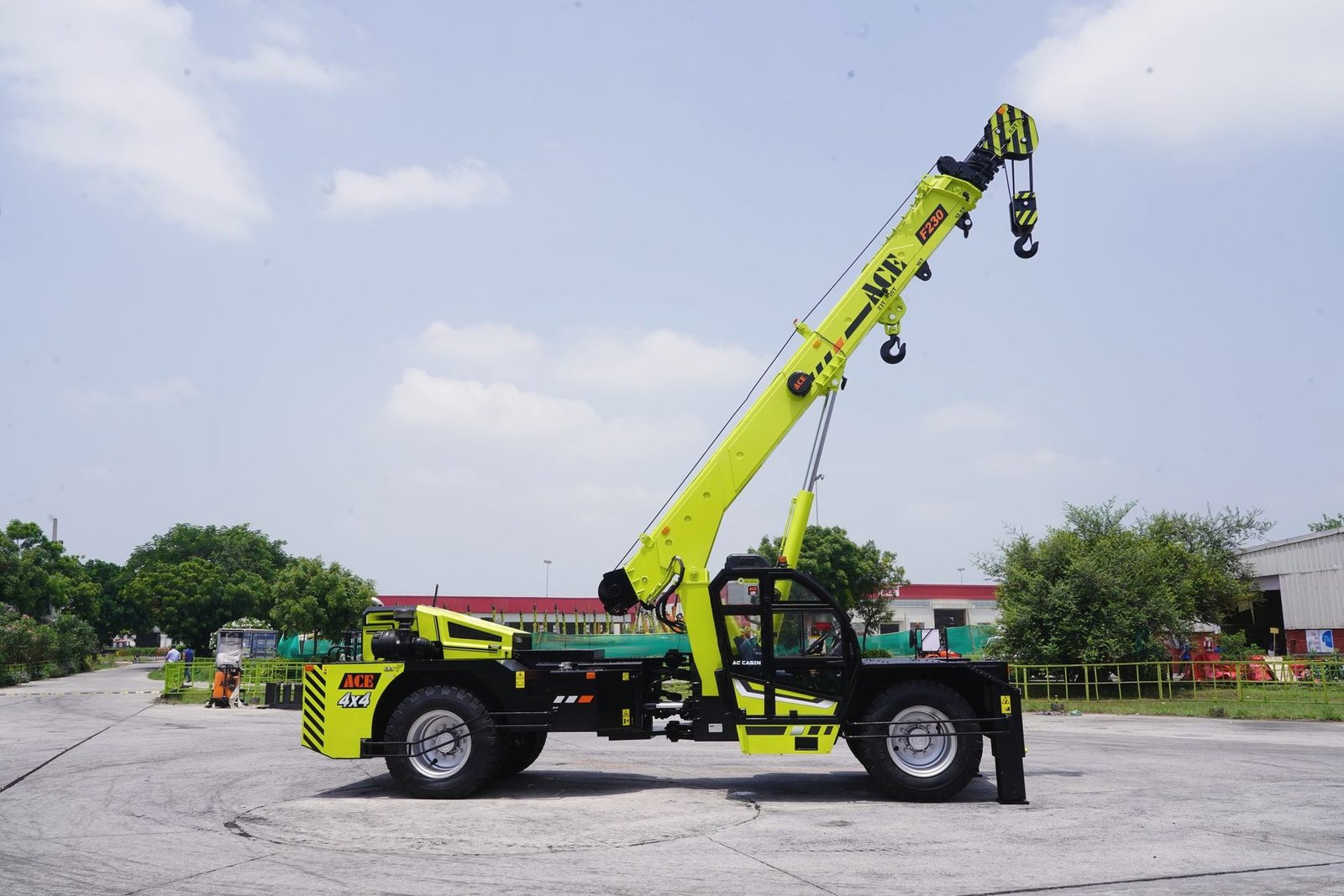 A mobile telescopic handler with its boom raised on a yard.